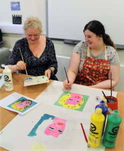 ESPA student and ESPA staff member painting the Andy Warhol version of Marilyn Monroe. [CNS]